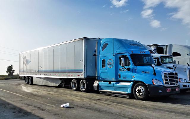 Heavy blue truck running on a highway