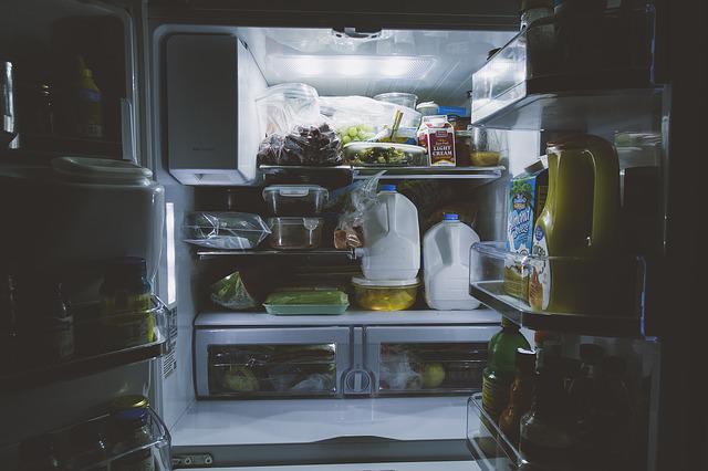 An opened refrigerator full of foods